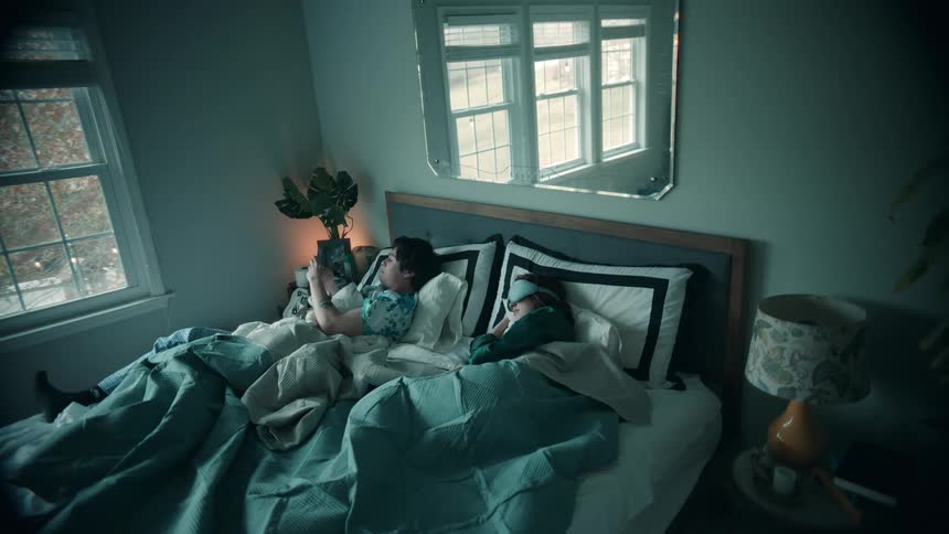 The man wakes up and checks his phone
