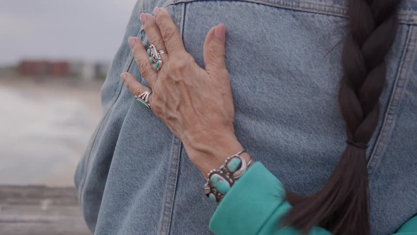 A person rubbing the shoulder of a friend