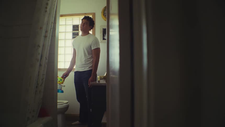 Man removing a toy from the toilet