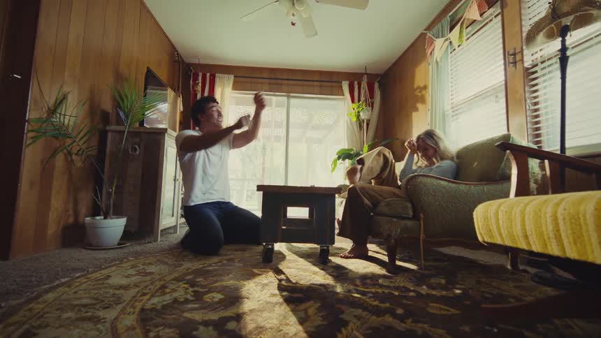 People talking and celebrating in a sunlit living room