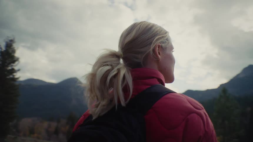 Two young women admiring nature while on an outdoor hike in a forest area during daytime