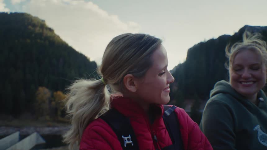 Two women outdoors smiling and laughing