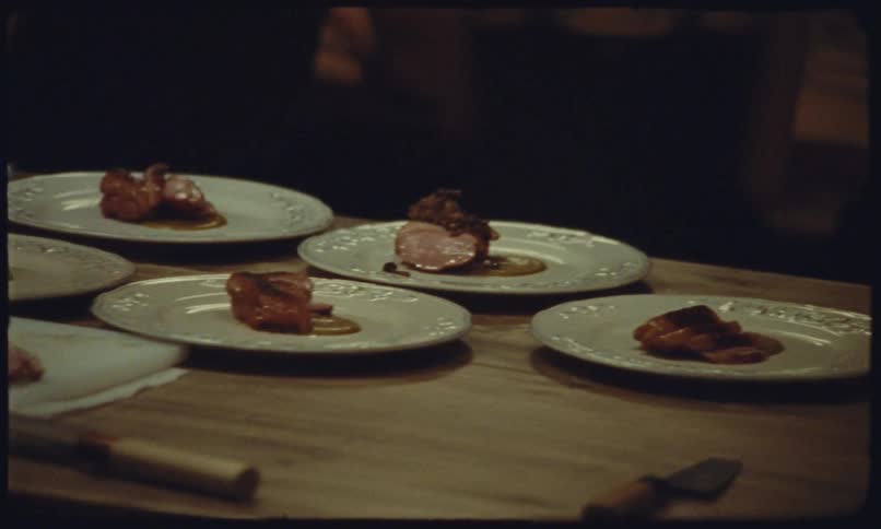 The chef is plating a line of dishes