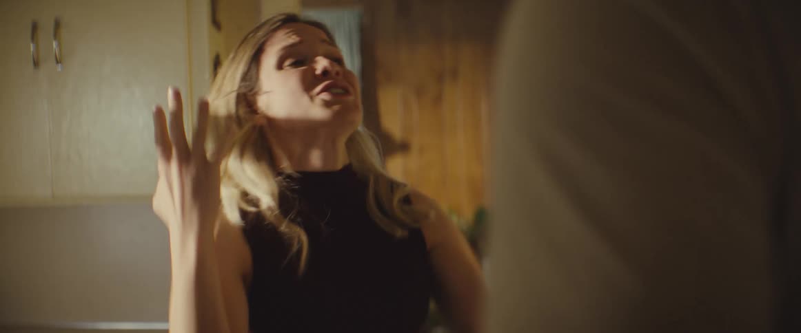 A distressed woman argues heatedly with her partner gesturing wildly and aggressively shoving them with both hands