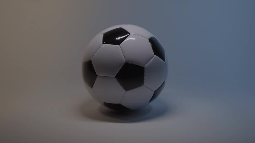 Black and white soccer ball lit by soft blue light
