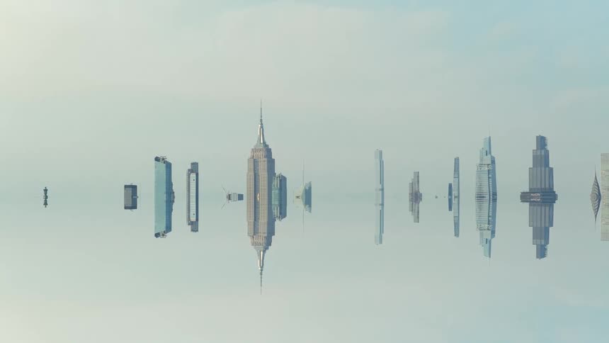 This is a visually abstract video clip that shows the skyline of a major city likely new york featuring the empire state building at the center emerging from a blurred backgroundthe city appears as a perfectly symmetrical reflection with the skyli