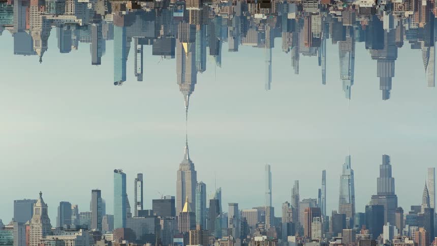 A surreal visual effect shows a densely packed city skyline mirrored vertically creating a continuous row of skyscrapers separated by a narrow gap of pale sky