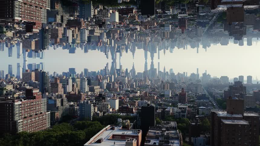 A sunlit city skyline is mirrored vertically creating a surreal symmetrical world with skyscrapers extending both up and down