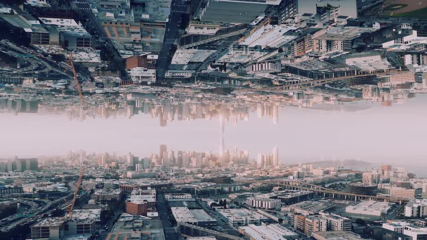 A vast surreal urban cityscape reflected upside down in the middle is looking forward in a symmetrical dramatic perspective
