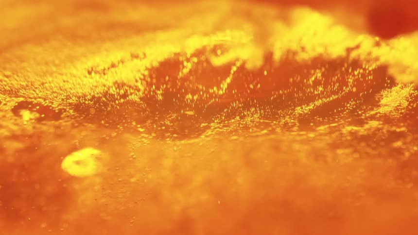 Closeup surface lit by intense orange tones resembling heated material