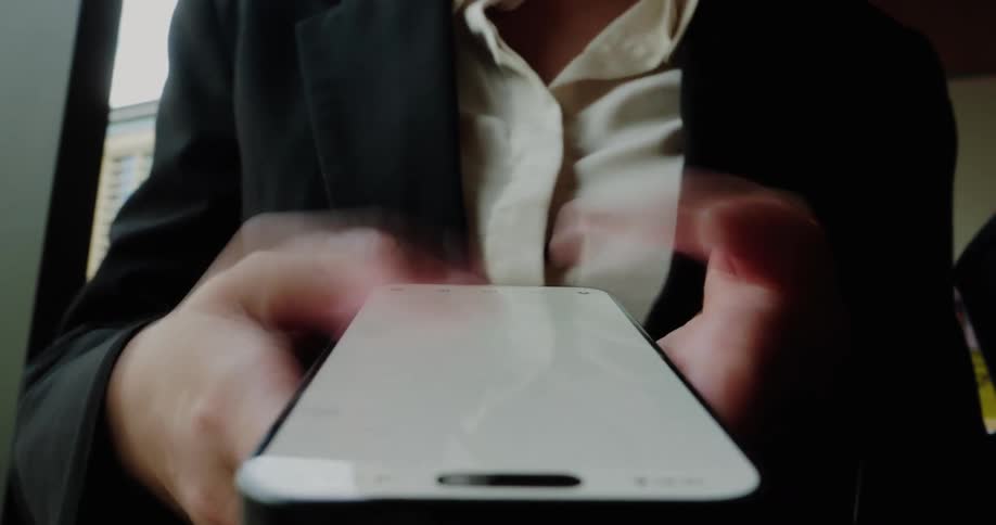 A woman is scrolling on her cellphone