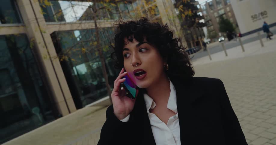 A woman talking on a phone outdoors