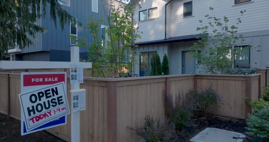 Descending twist past a brand new townhome to reveal a real estate sign that prominently advertises an open house today