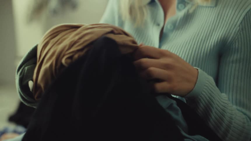 Adult woman sorting clothes indoors