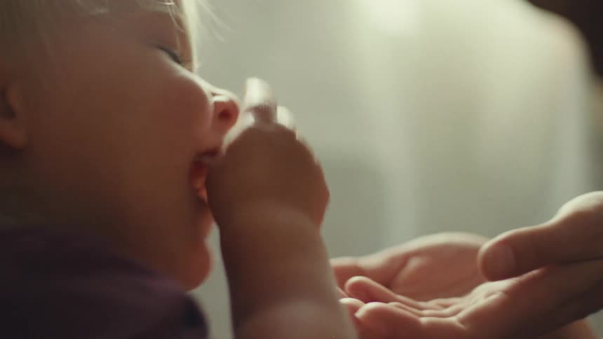 A child playing with mother excitedly indoor