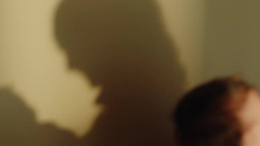 Shadow of mother and child on the wall