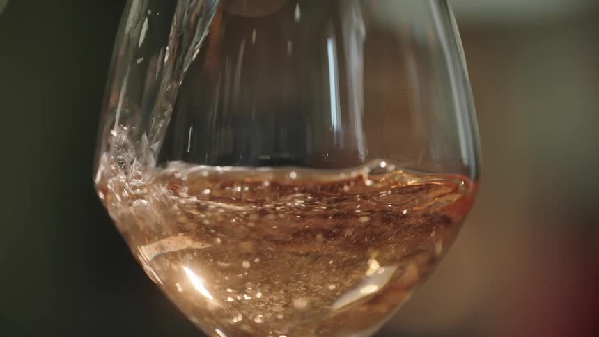 Wine pours into a clear glass