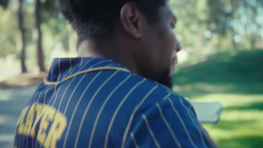 Man watching something on his smartphone while enjoying himself outdoors