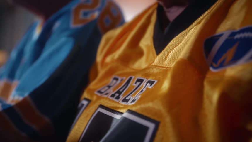 Couple watching the game wearing sports jerseys