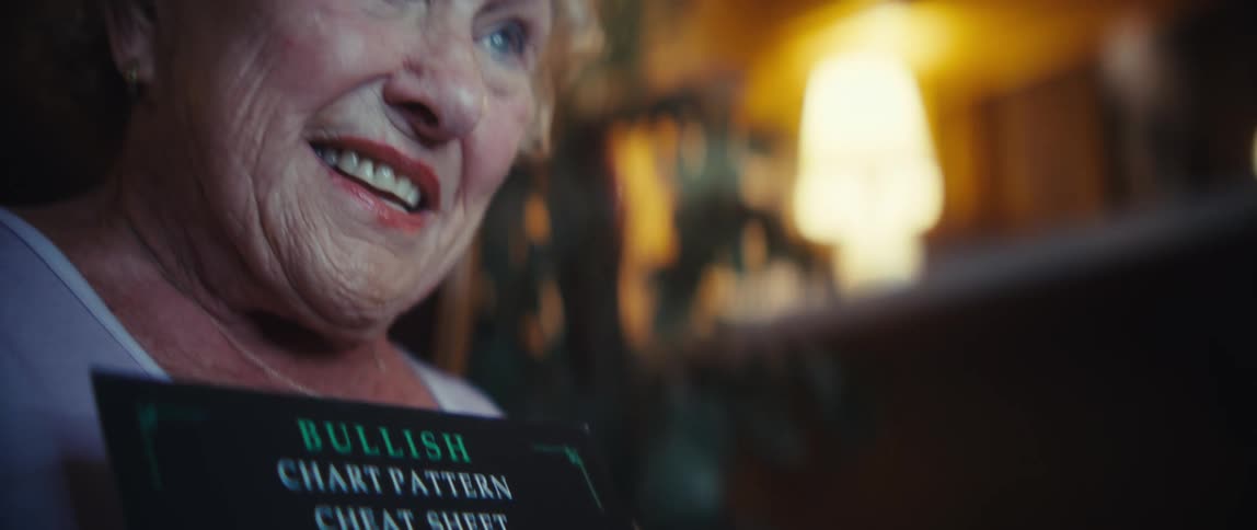 Elderly womans hand pointing to a sheet with graphic patterns for technical analysis