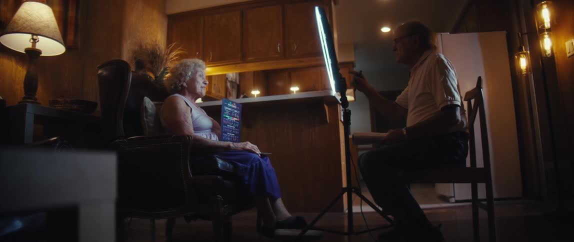 A man filming a woman with a smartphone