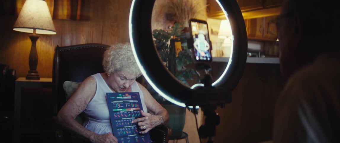 A man and woman filming with a ring light
