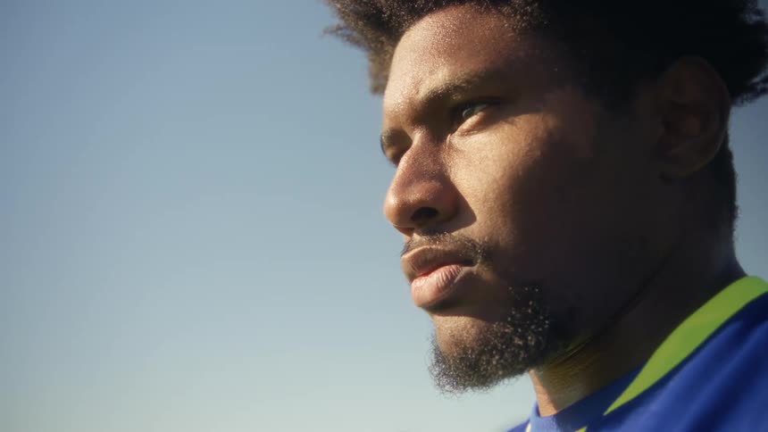 Man in a blue uniform in a closeup outdoors under a clear sky