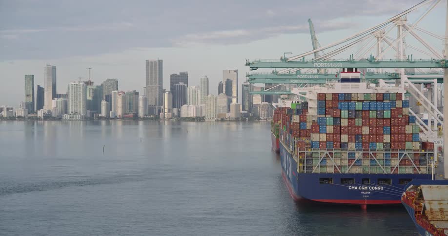 Container ship docked in front of the urban skyline