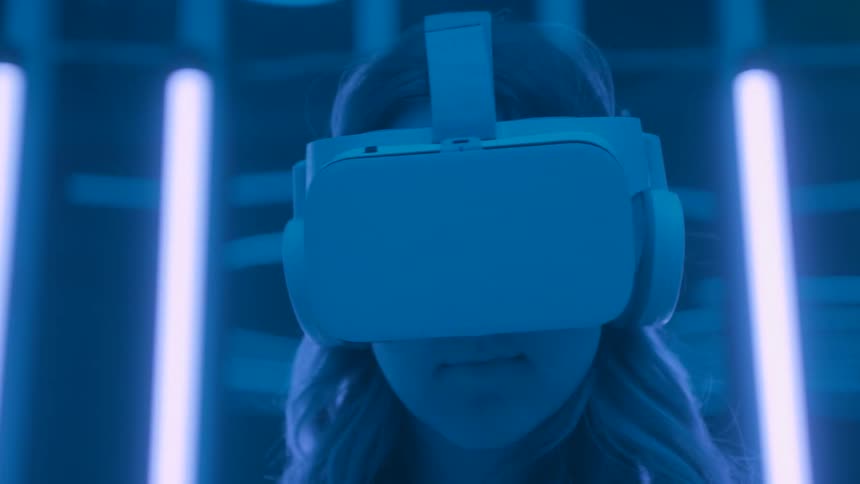 The woman is wearing a virtual reality headset