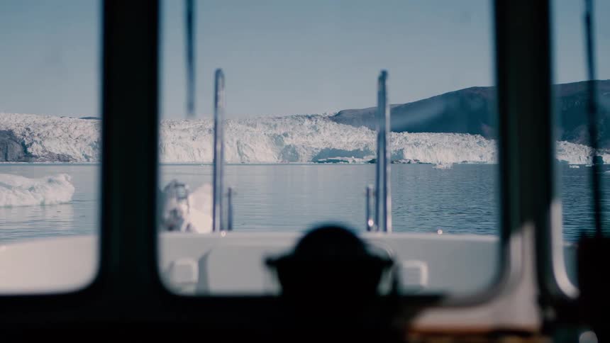 A ship sailing through some sea ice