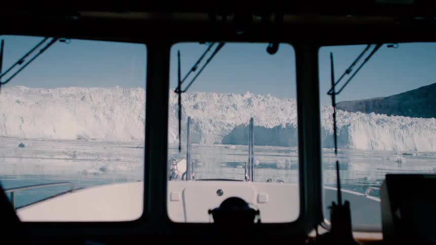 View from a boat sailing near a glacier on arctic water