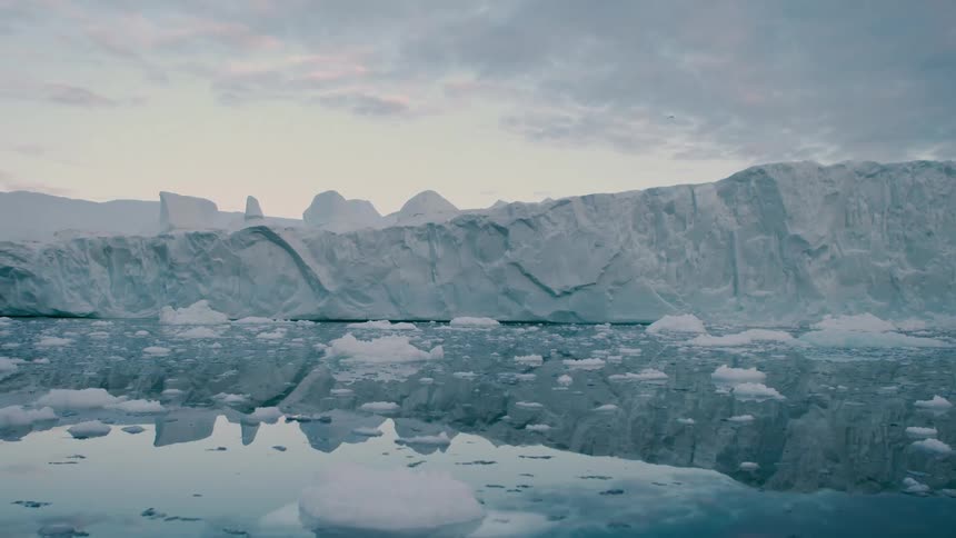 Arctic glacier with melting ice floating on the water