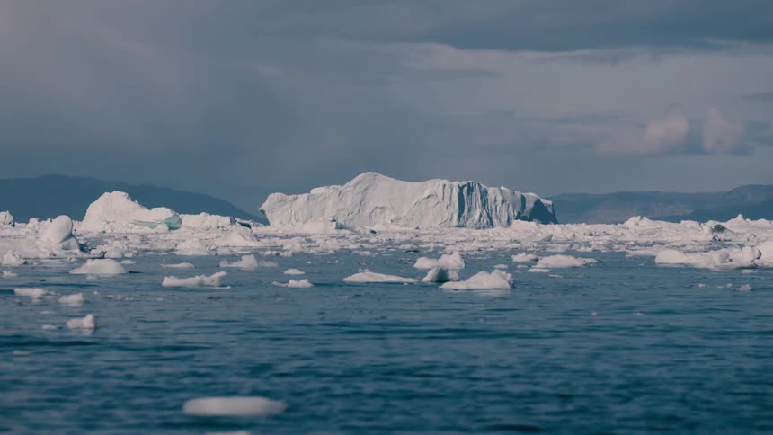 Icebergs and melting ice floating on the arctic water