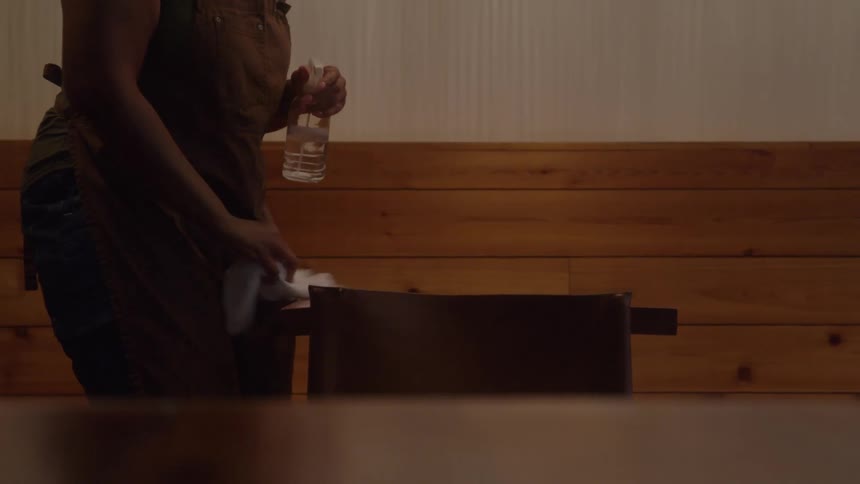 Two women cleaning up a room