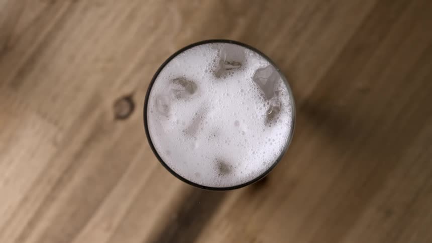 Looking down at a glass full of liquid