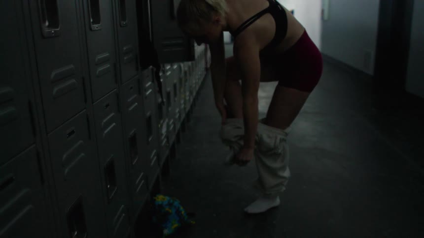 A woman changing clothes at a gym