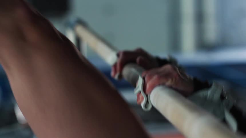 A woman does a routine on the uneven bars