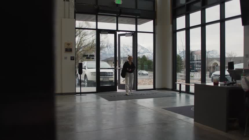 A young woman walking into a reception during daytime