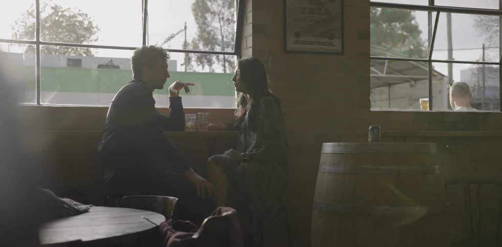 A man and woman talk together in a restaurant