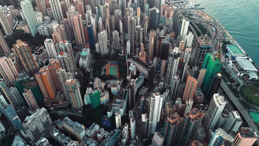A city with hundreds of buildings is on a river