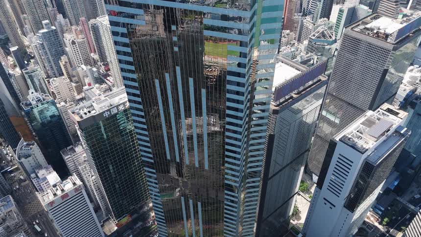 Aerial view of a dense urban skyline dominated by modern glass skyscrapers