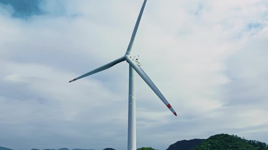 Wind turbine spinning under a cloudy sky