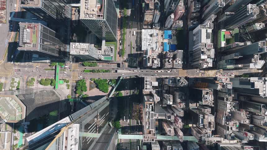 Vertical aerial view of a dense urban area with aligned skyscrapers in downtown hong kong