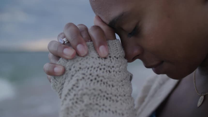A woman looking sad out near the beach