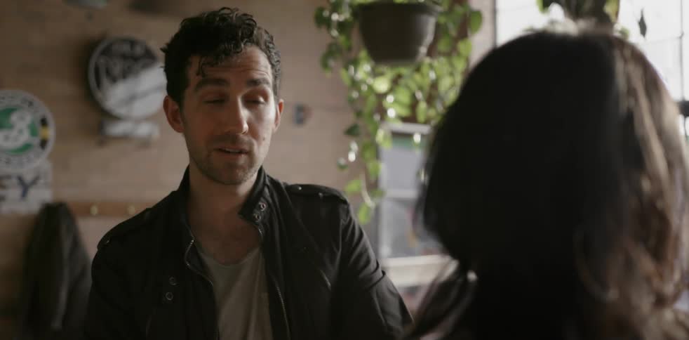 Man and woman talk in a cafe