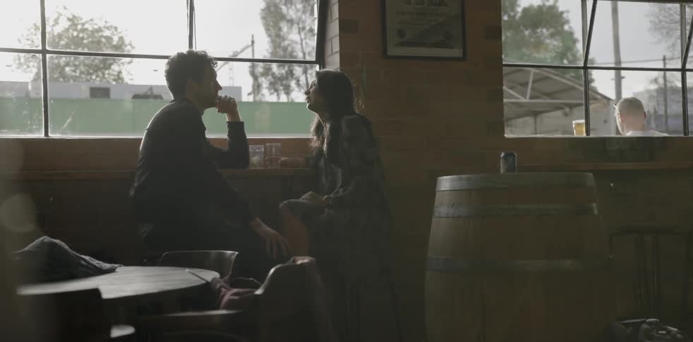 A man and woman talk in a restaurant