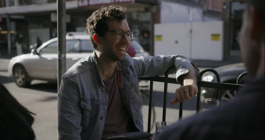 A man is talking to two people outside