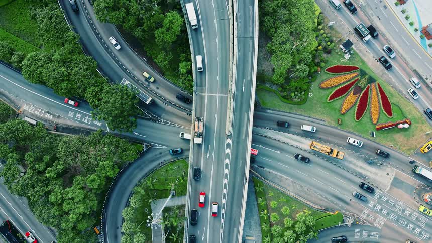 Heavy traffic at a flyover and an intersection under it outdoors during day time