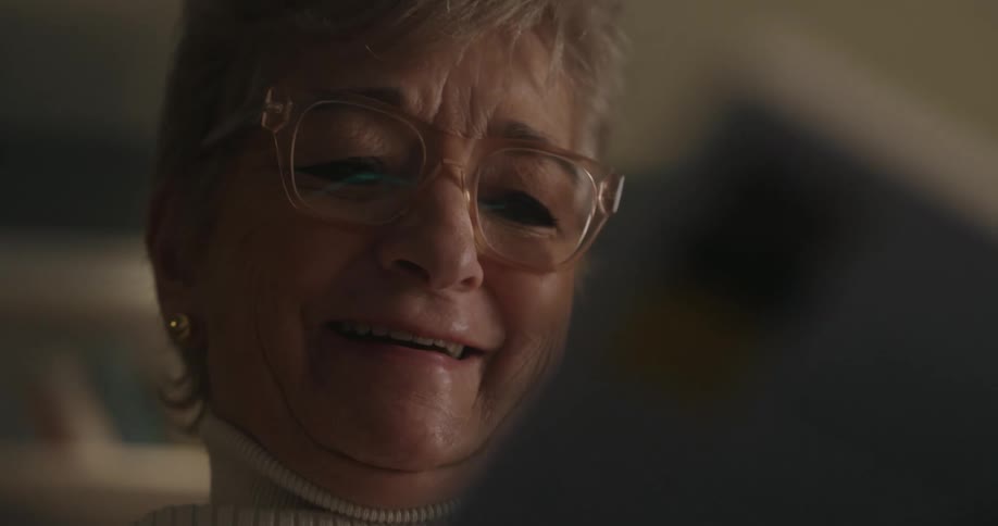 Close up portrait of an elderly woman on a mobile video call while sitting in a room during daytime