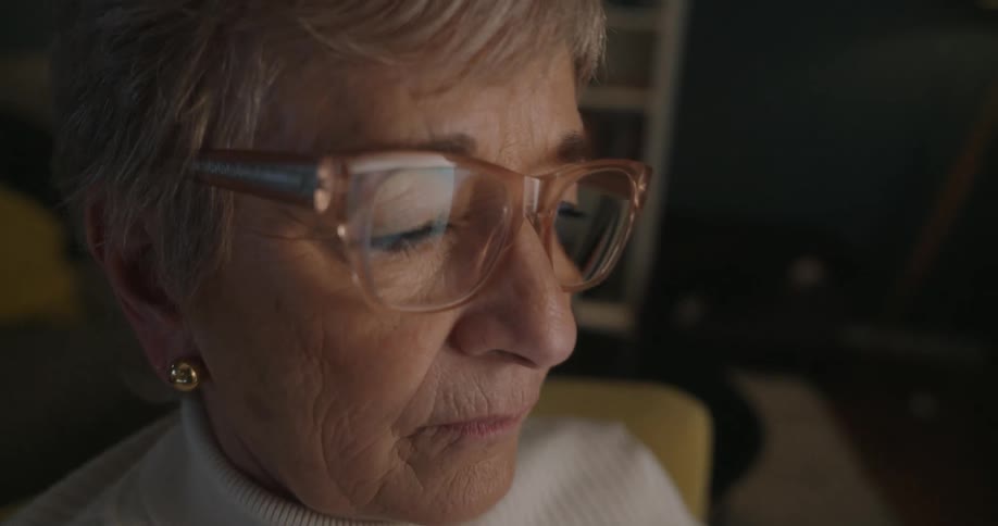 The woman is viewing the display on her cell phone